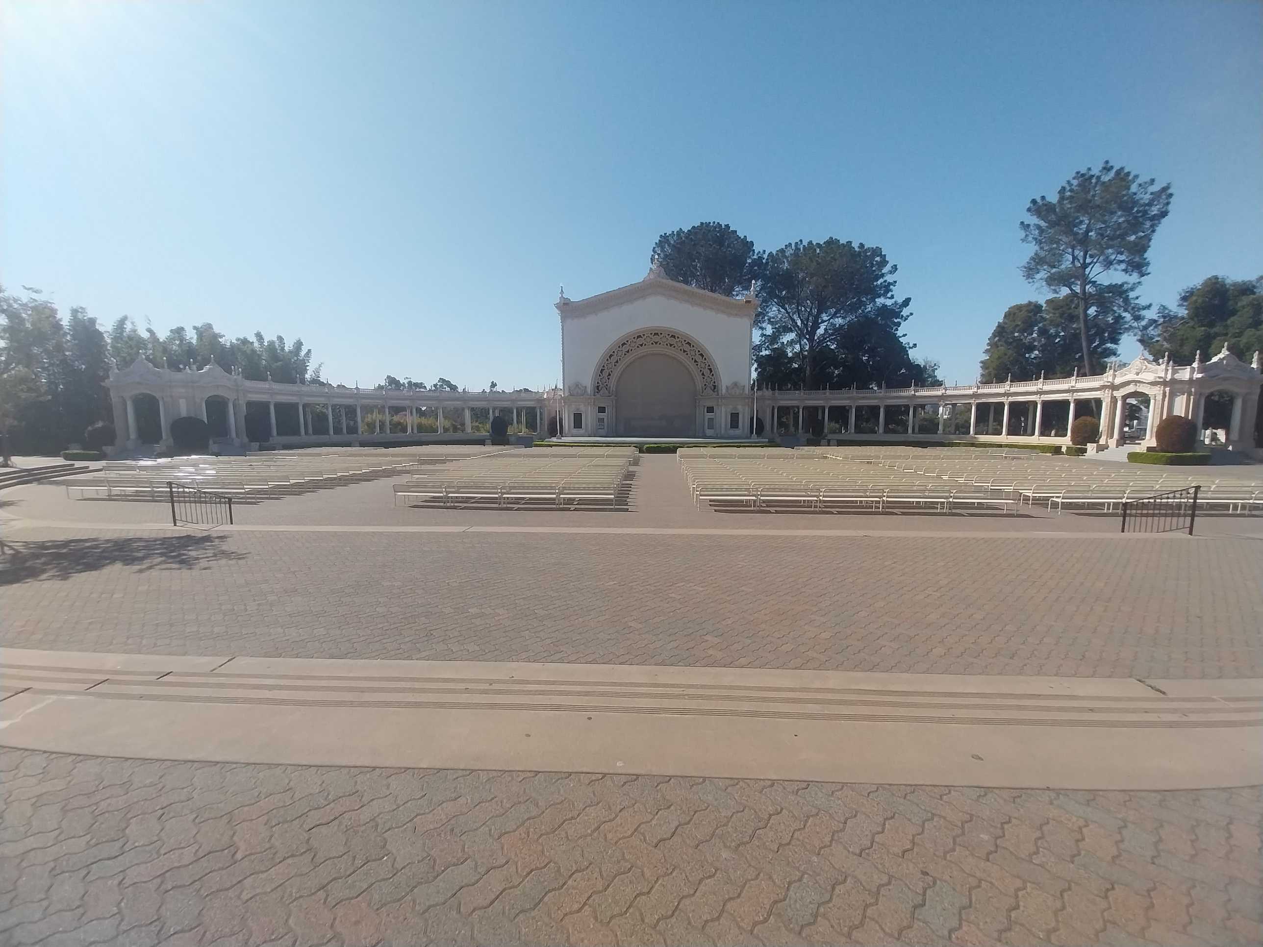 A sunlit view of Spreckels Organ Pavilion, currently empty of people.