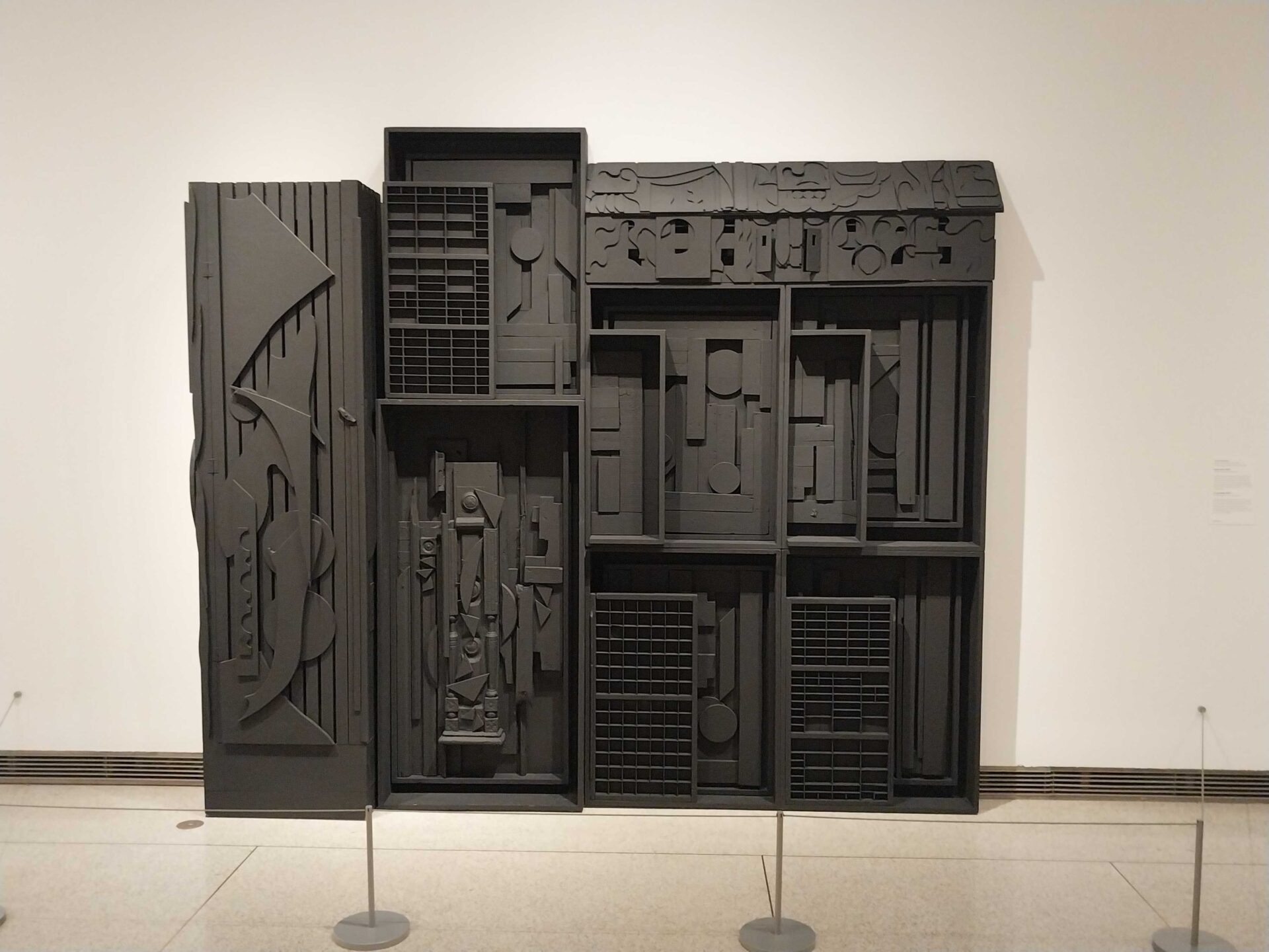 Louise Nevelson's Dream House Wall II, a black-painted installation that presents nuances of form, light, and shadow.