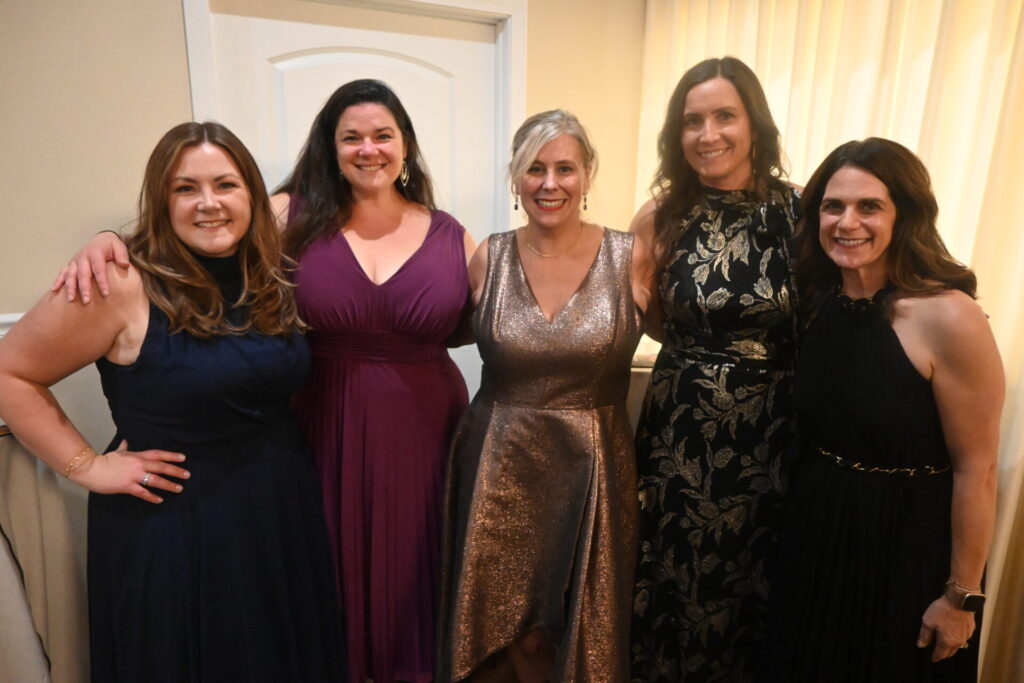 Five members of Aspiritech senior leadership in a group photo. 