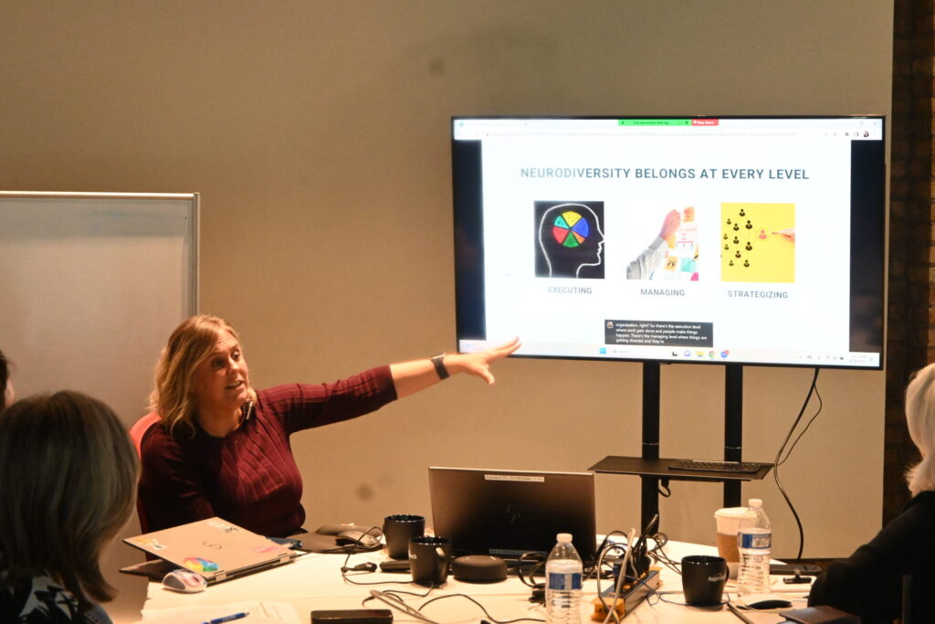 Aspiritech CEO Tara May presents a slide the reads "Neurodiversity Belongs At Every Level."