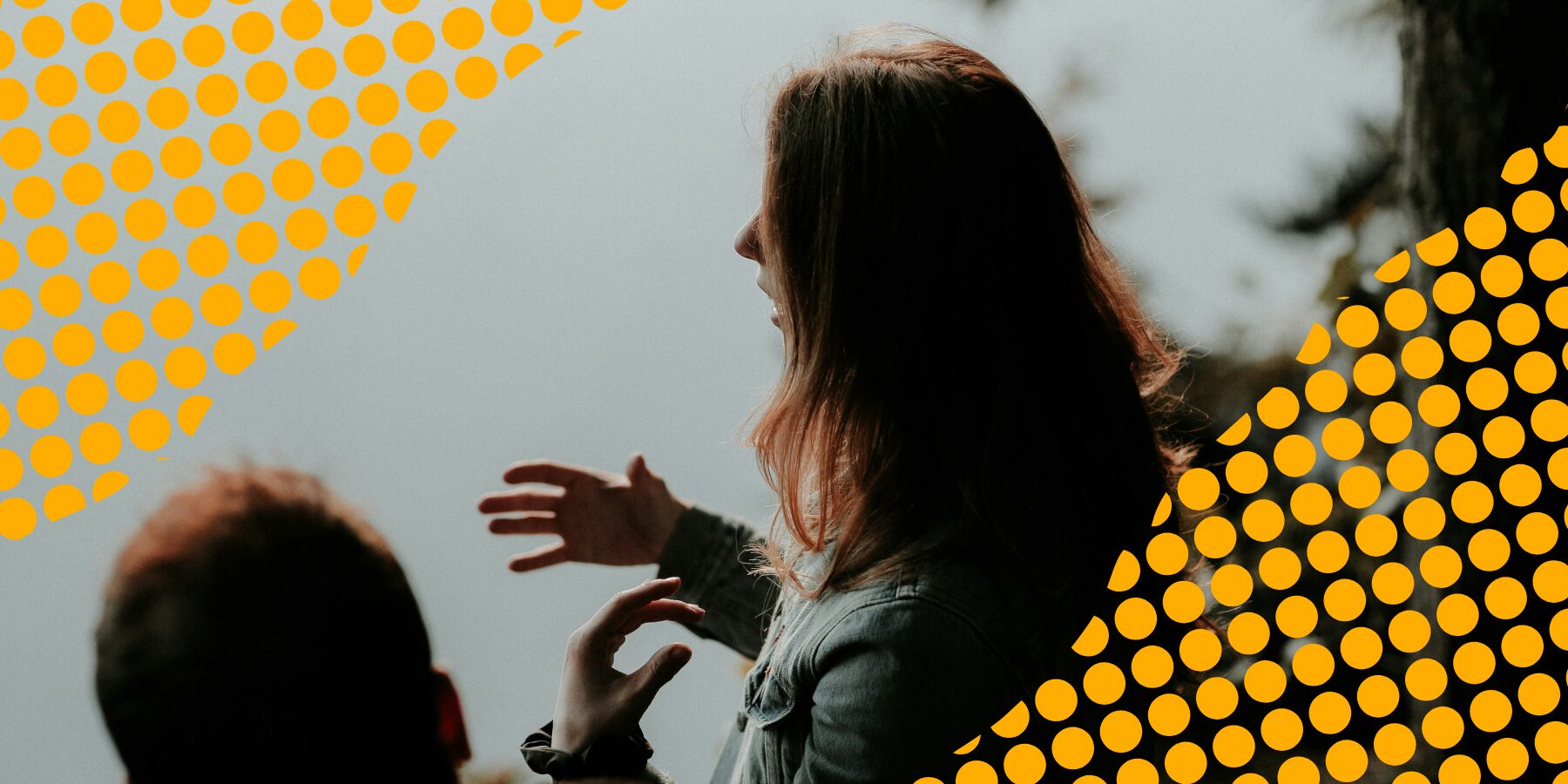 A silhouette of a woman explaining something to a man beside her.