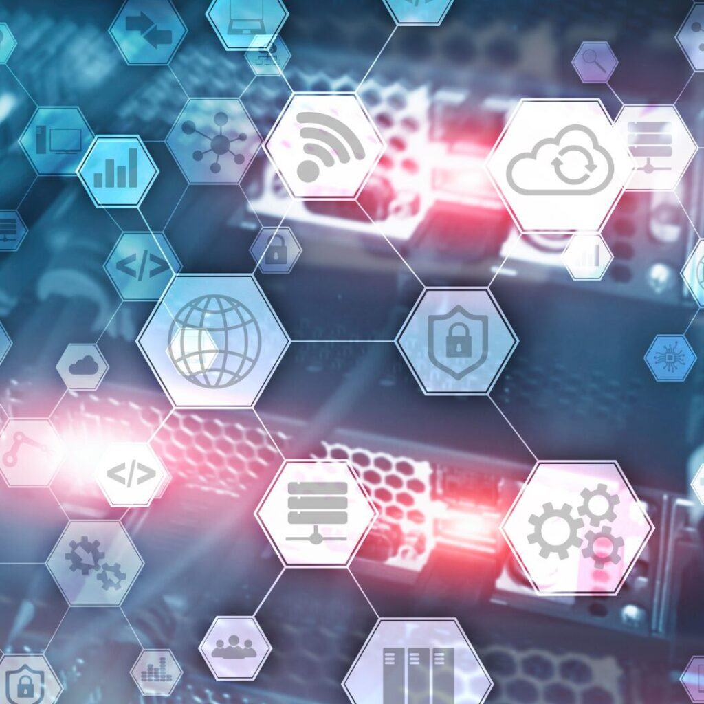 An assortment of hexagons featuring tech symbols against a background of computer hardware.