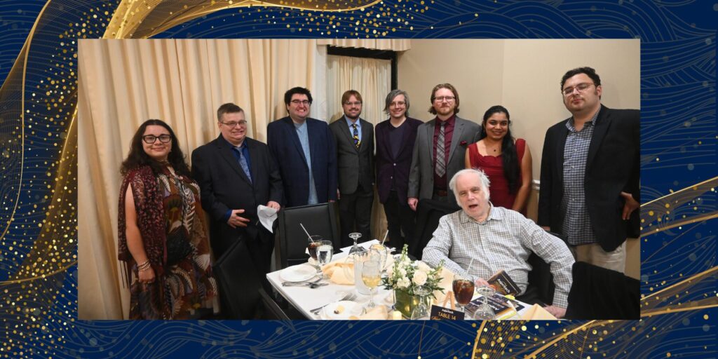 Nine Aspiritech team members in formal wear take a group photo at the 2025 Shine the Light Gala.
