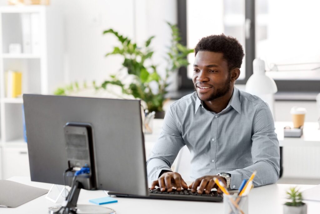 A man works at a desktop computer.